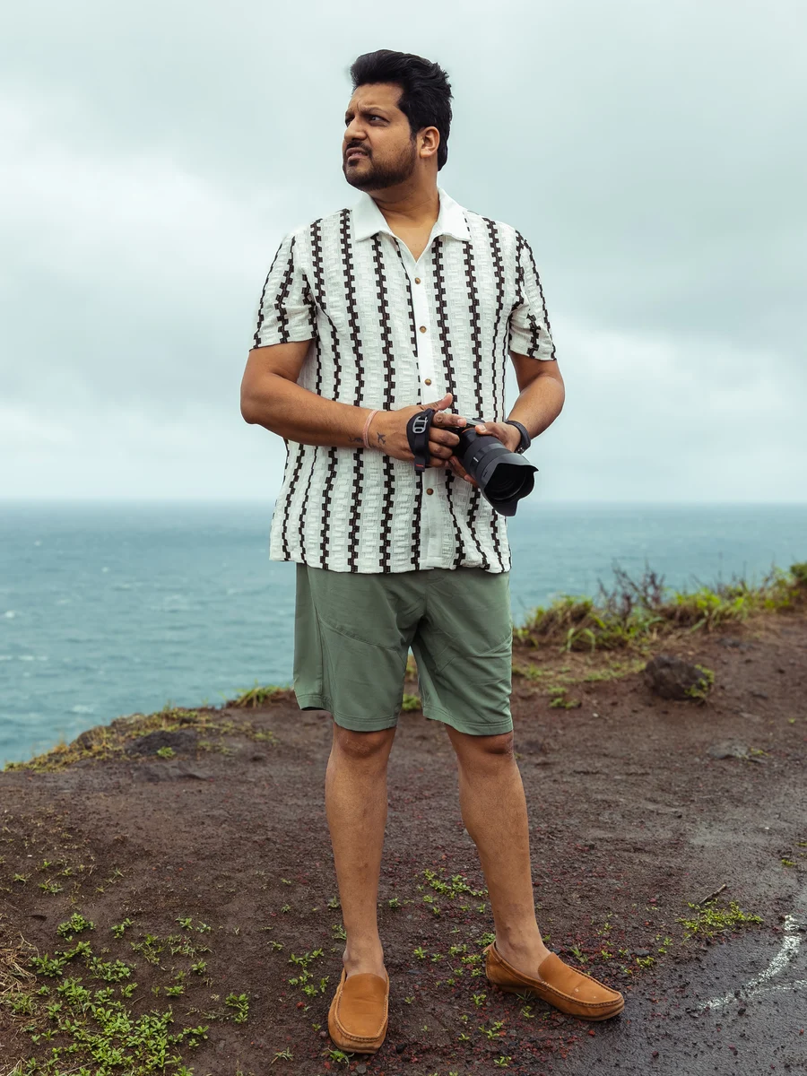Azar holding his camera beside the ocean, Wailuku, Hawaii