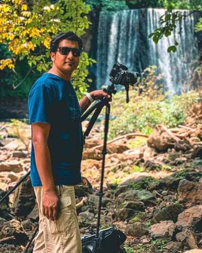 Azar with a camera beside El Encanto waterfall, Puntarenas