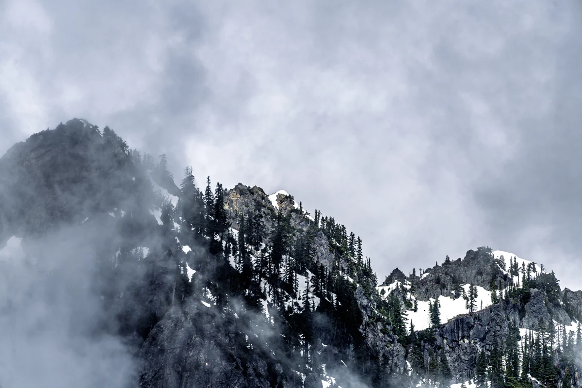 Snowy crag emerging from mist, Snoqualmie Pass, Washington