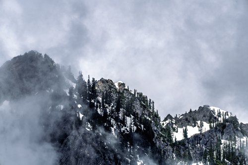 Snowy crag emerging from mist, Snoqualmie Pass, Washington
