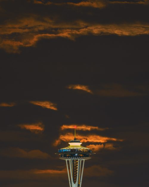 Moonrise behind clouds and the Space Needle, Seattle, Washington