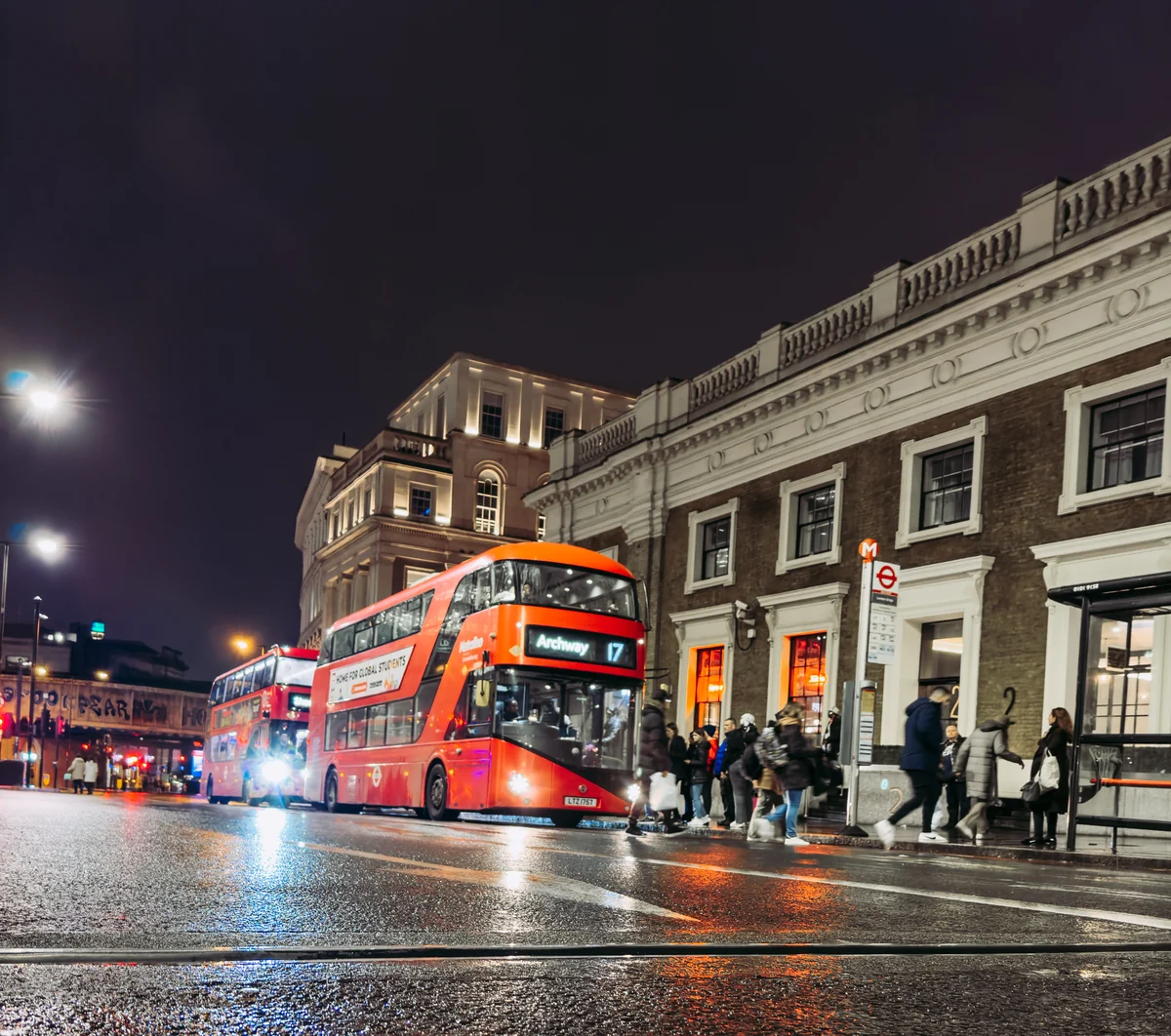 Red bus on a London night street, England
