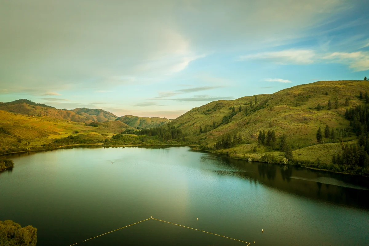 Lake between sunlit hills, Okanogan County, Washington